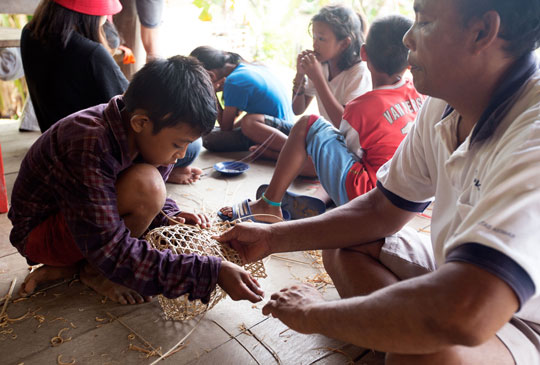 YPBM student learning to weave Mentawai basket