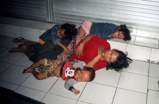 Mother and her children sleeping on the streets in Bali, Indonesia